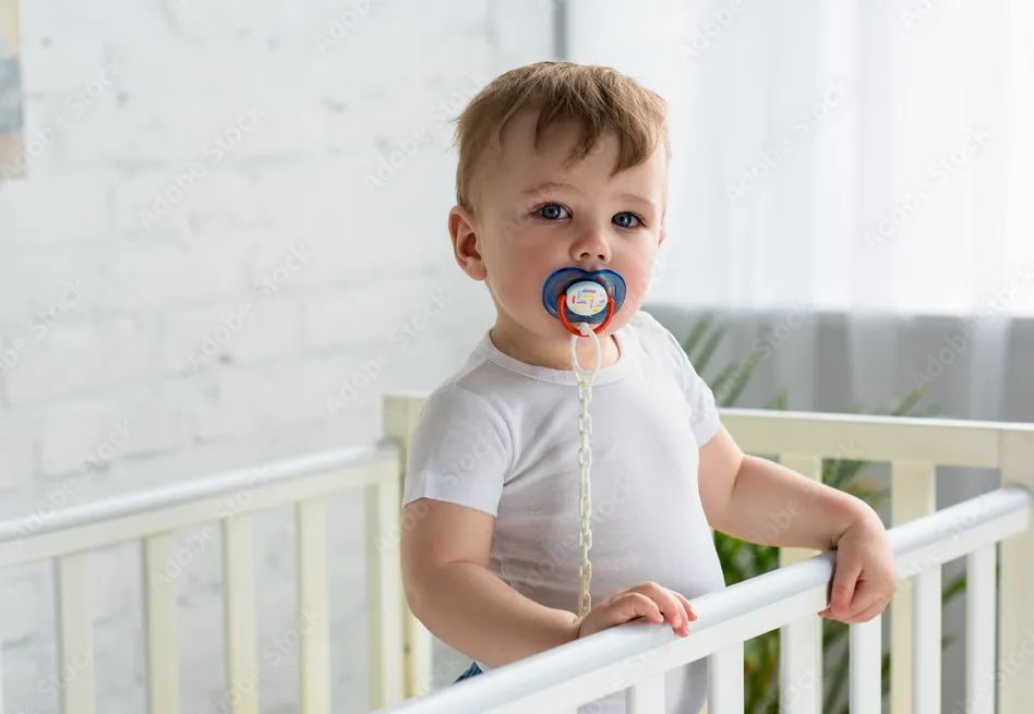 A toddler with long string Personalized Pacifier Clips